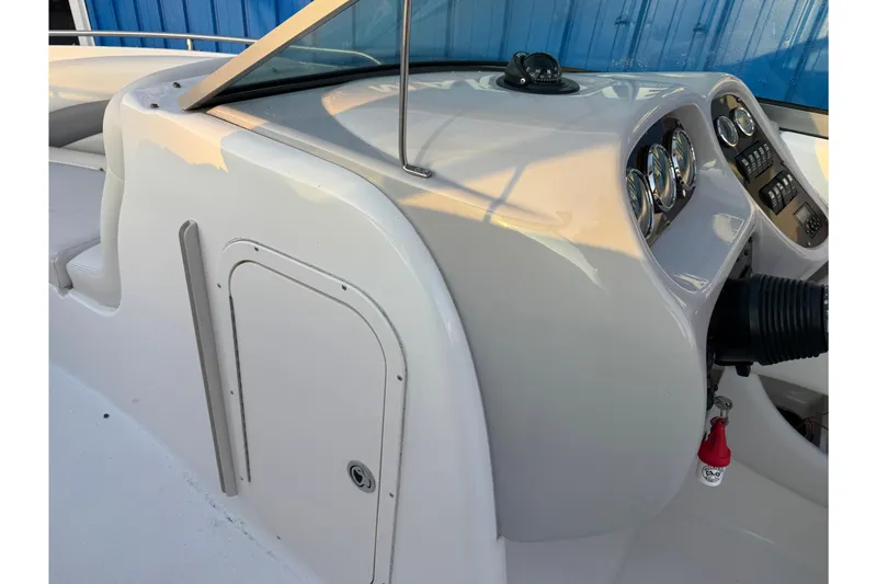 Slide: The Image of 2007 Chaparral 256 SSi boat dashboard with gauges and controls, featuring sleek design. - 13