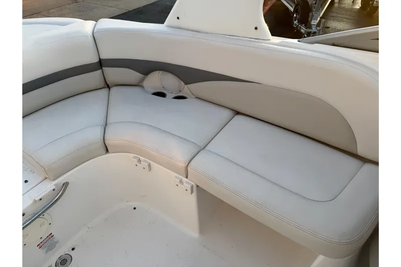 Slide: The Image of 2007 Chaparral 256 SSi boat interior with white cushioned seating. - 18