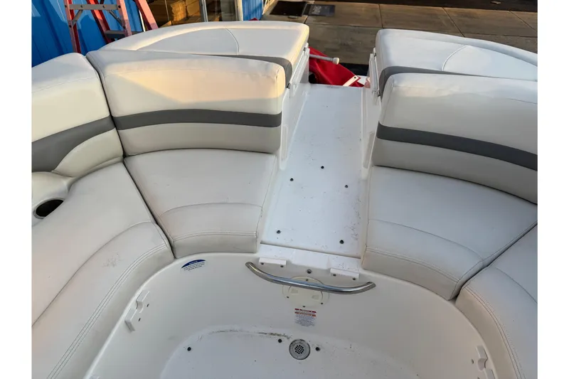 Slide: The Image of 2007 Chaparral 256 SSi boat interior with white cushioned seating and storage area. - 19