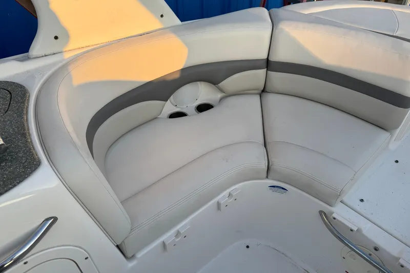Slide: The Image of 2007 Chaparral 256 SSi boat interior with white cushioned seating and cup holders. - 20