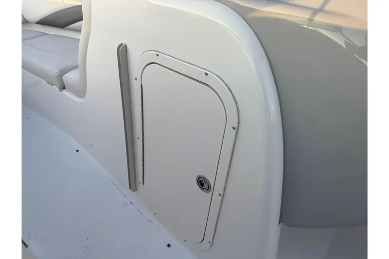 Slide: The Image of 2007 Chaparral 256 SSi boat interior with storage compartment and seating area. - 25