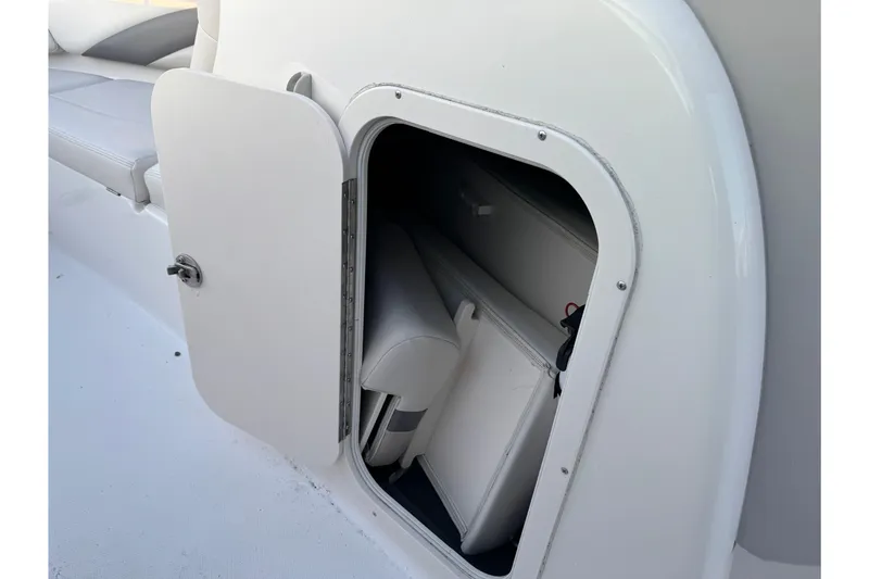 Slide: The Image of Open storage compartment on 2007 Chaparral 256 SSi boat, showing interior seating. - 26