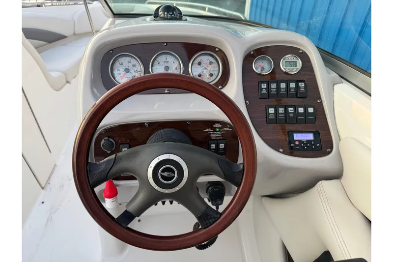 Slide: The Image of 2007 Chaparral 256 SSi boat dashboard with gauges, controls, and steering wheel. - 29