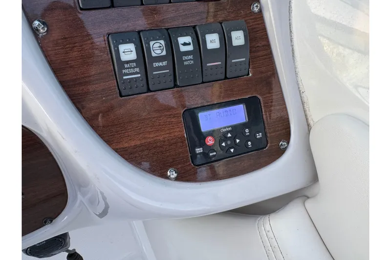 Slide: The Image of Control panel of 2007 Chaparral 256 SSi boat with audio system and switches. - 32