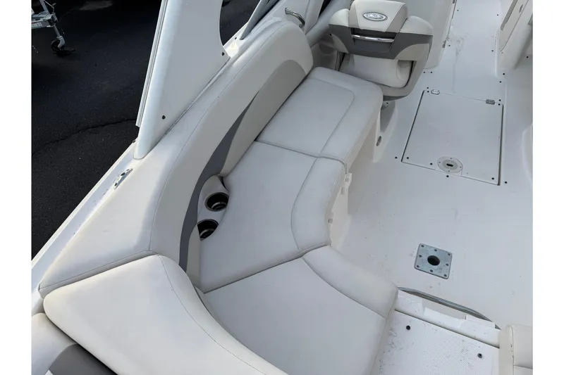 Slide: The Image of 2007 Chaparral 256 SSi boat interior with white seating and cup holders. - 34