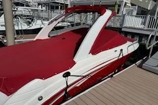 Slide: The Image of 2007 Chaparral 256 SSi boat with red cover docked at marina. - 47