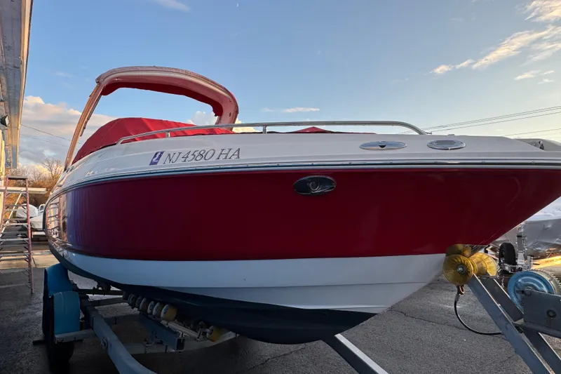Slide: The Image of 2007 Chaparral 256 SSi boat with red and white exterior on a trailer. - 48