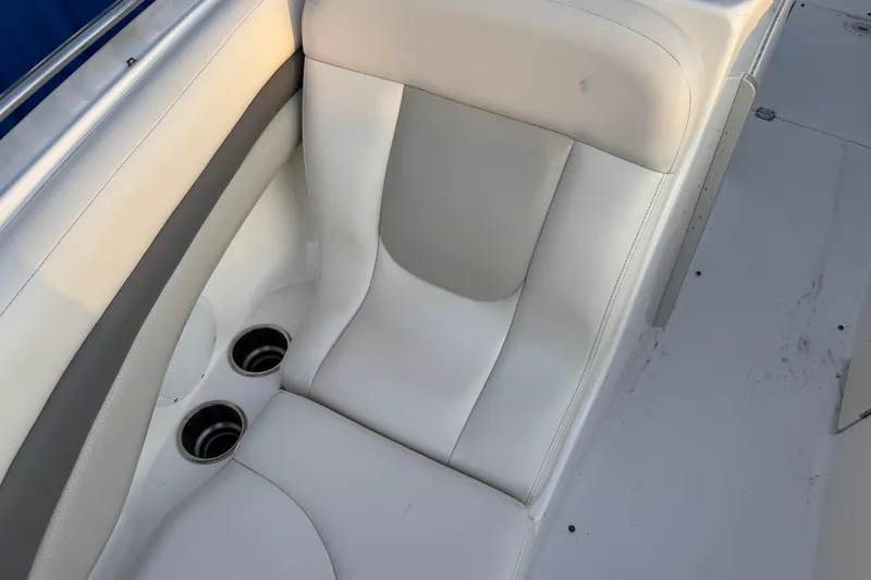 Slide: The Image of White leather seating on a 2007 Chaparral 256 SSi boat with cup holders. - 6