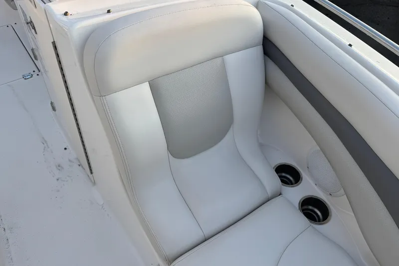 Slide: The Image of 2007 Chaparral 256 SSi boat interior with white seating and cup holders. - 7