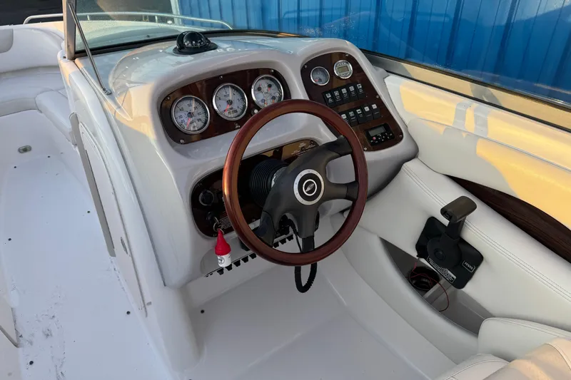 Slide: The Image of 2007 Chaparral 256 SSi boat dashboard with gauges and steering wheel. - 9