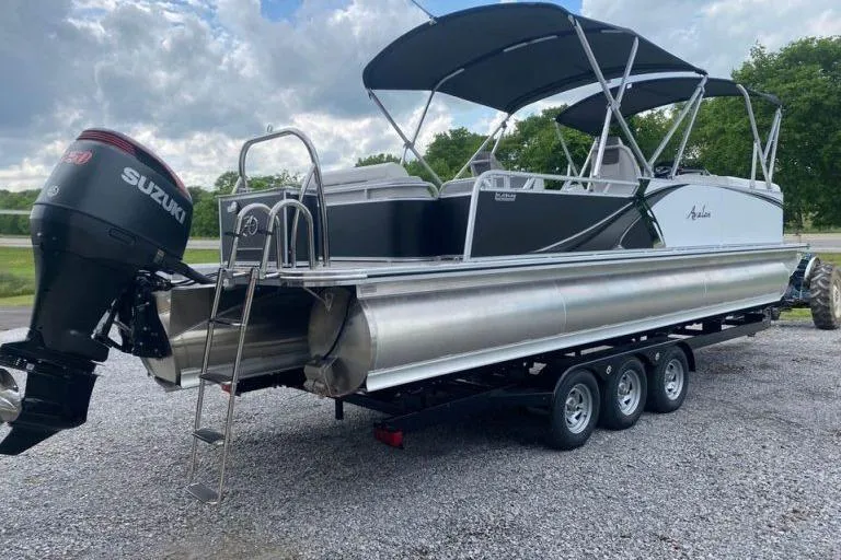 Slide: The Image of 2024 Avalon LSZ 2585 VRL pontoon boat with Suzuki outboard motor on a trailer. - 3
