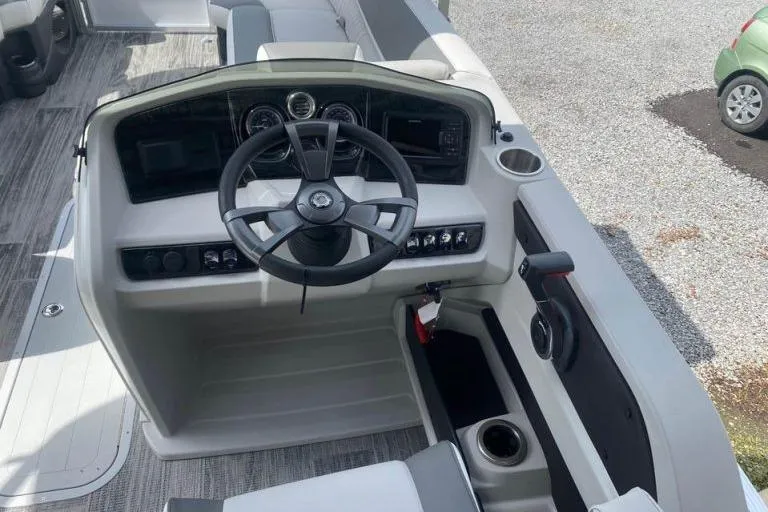 Slide: The Image of 2024 Avalon LSZ 2585 VRL boat dashboard with steering wheel and controls. - 6