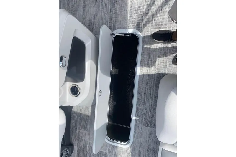 Slide: The Image of 2024 Avalon LSZ 2585 VRL boat interior storage compartment open on deck. - 8