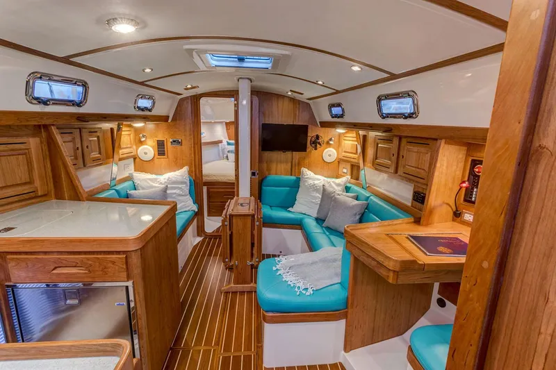 Slide: The Image of Manufacturer Provided Image: Luxurious interior of 2026 Tartan 365 yacht with teal seating and wooden finishes. - 4
