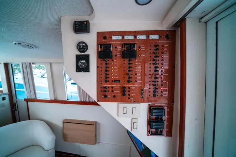 Slide: The Image of Control panel inside 2003 Mainship 390 Trawler, featuring gauges and switches. - 10