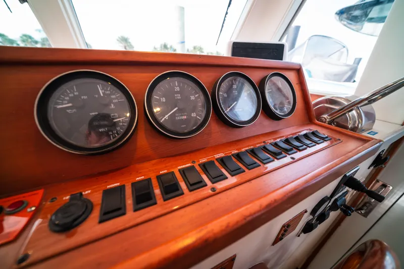 Slide: The Image of 2003 Mainship 390 Trawler dashboard with gauges and control switches. - 14