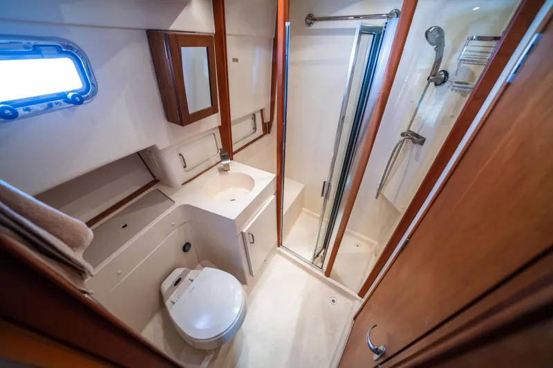 Slide: The Image of Bathroom interior of 2003 Mainship 390 Trawler with shower, sink, and toilet. - 18