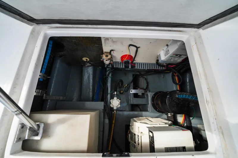 Slide: The Image of Engine compartment of 2003 Mainship 390 Trawler, showcasing mechanical components and wiring. - 19