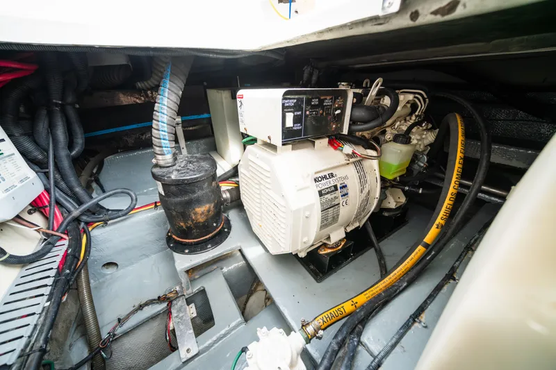 Slide: The Image of Engine room of 2003 Mainship 390 Trawler with Kohler power system and exhaust hose. - 20