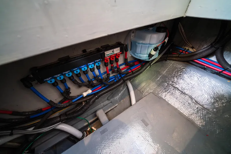 Slide: The Image of Electrical wiring and components inside a 2003 Mainship 390 Trawler boat. - 22