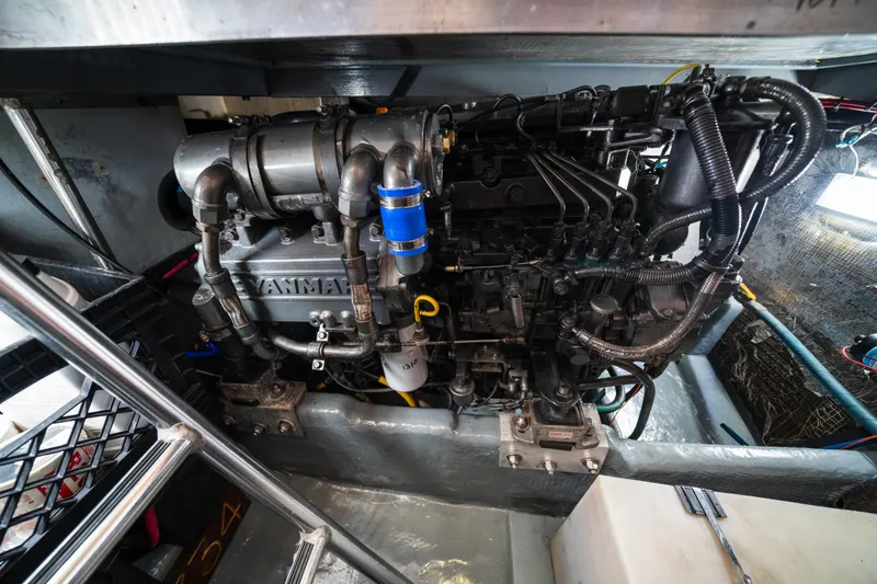 Slide: The Image of Engine compartment of a 2003 Mainship 390 Trawler, featuring a Yanmar marine engine. - 27