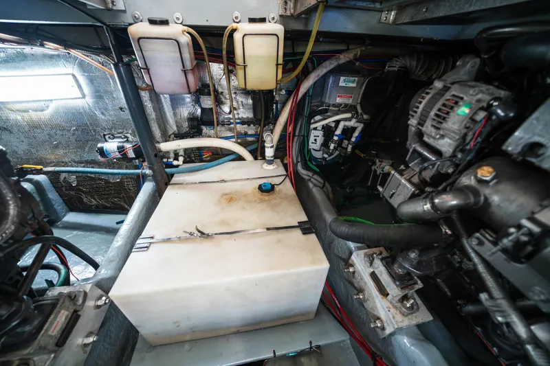 Slide: The Image of Engine room of a 2003 Mainship 390 Trawler, showcasing mechanical components and wiring. - 28