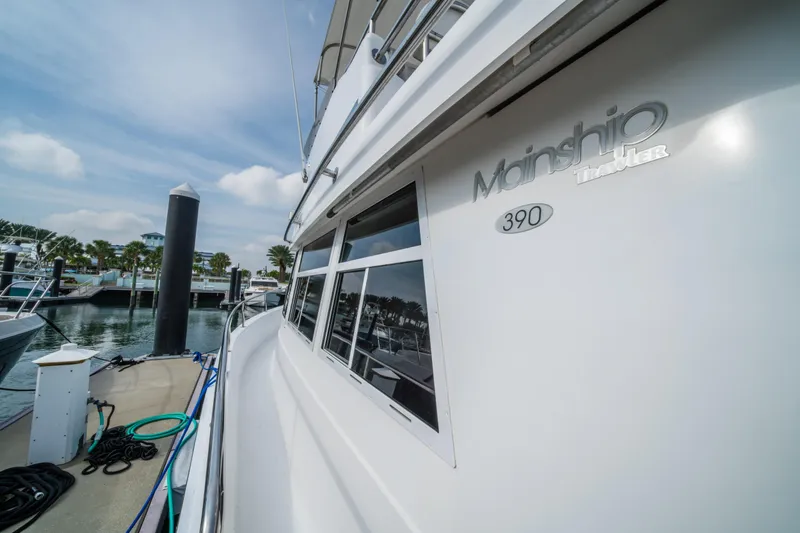 Slide: The Image of 2003 Mainship 390 Trawler docked at marina under blue sky. - 3