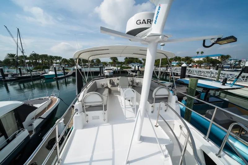 Slide: The Image of 2003 Mainship 390 Trawler docked at marina under clear blue sky. - 4