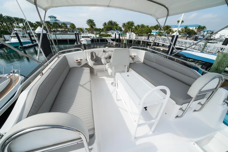 Slide: The Image of 2003 Mainship 390 Trawler flybridge with seating, docked at marina. - 5