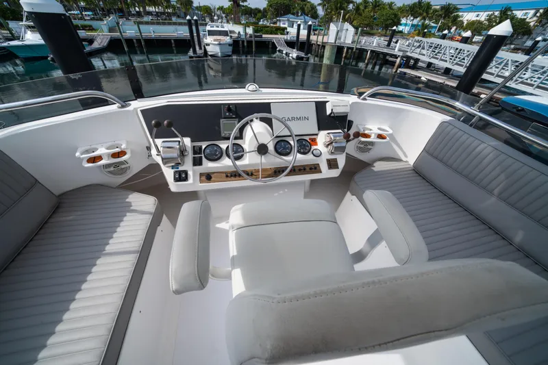 Slide: The Image of 2003 Mainship 390 Trawler helm with Garmin navigation, docked at marina. - 6