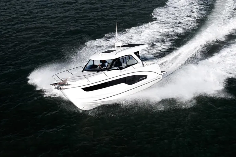 Slide: The Image of 2026 Beneteau Antares 9 with twin 250 V8 engines, rear view at a boat show. - 1