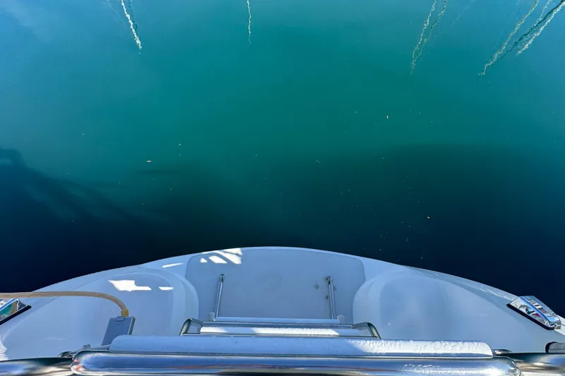 Slide: The Image of View from the stern of a 1997 Catalina 36 MkII sailboat over calm water. - 14