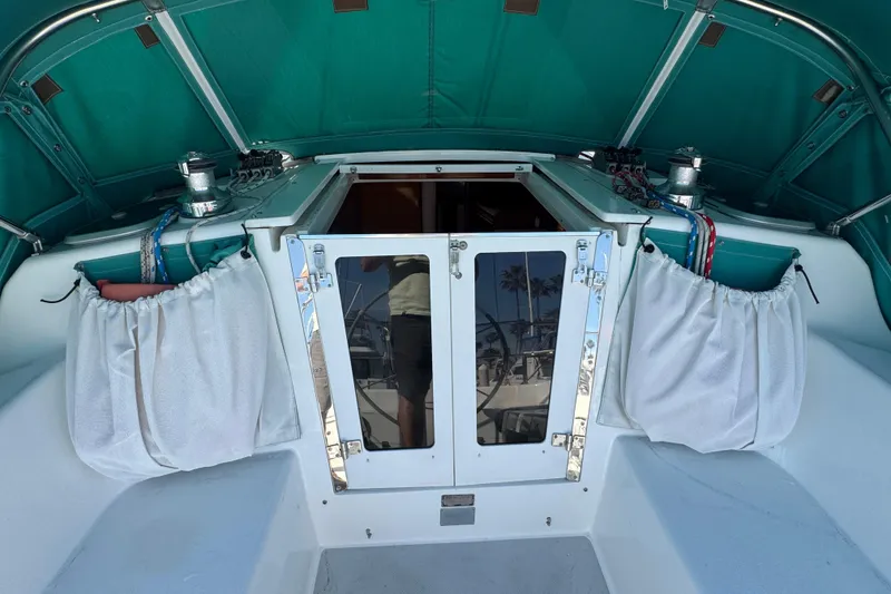 Slide: The Image of 1997 Catalina 36 MkII sailboat cockpit with teal canopy and white curtains. - 17