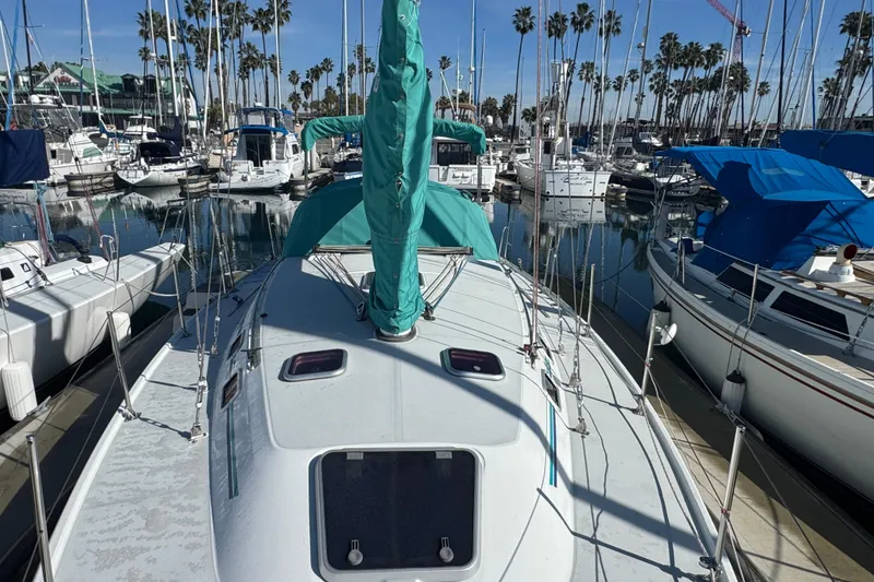 Slide: The Image of 1997 Catalina 36 MkII sailboat docked in a marina, surrounded by other boats. - 2