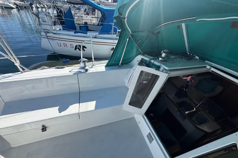 Slide: The Image of 1997 Catalina 36 MkII sailboat cockpit with green canopy and marina view. - 23