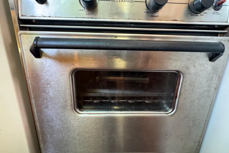 Slide: The Image of Stainless steel oven with black handle on a 1997 Catalina 36 MkII yacht. - 29