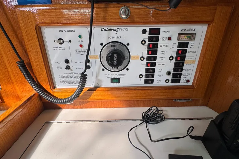 Slide: The Image of Electrical control panel of a 1997 Catalina 36 MkII yacht, featuring various switches and indicators. - 34