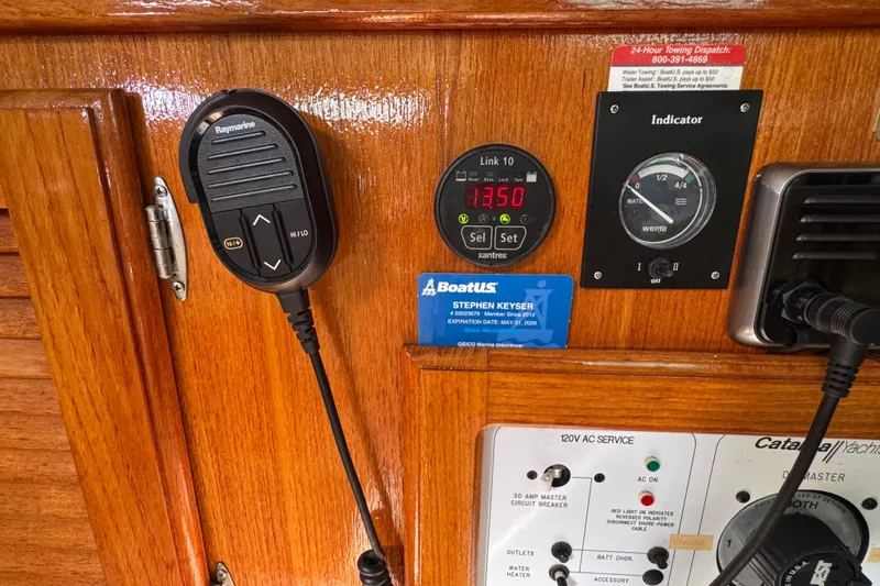 Slide: The Image of Control panel of a 1997 Catalina 36 MkII sailboat with various instruments and a microphone. - 36