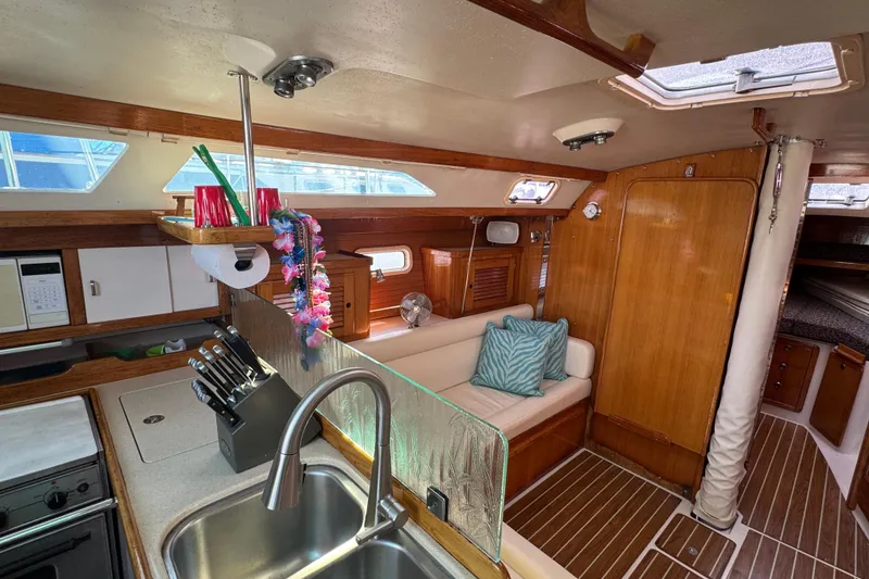 Slide: The Image of Interior of 1997 Catalina 36 MkII sailboat with cozy seating and modern kitchen amenities. - 37
