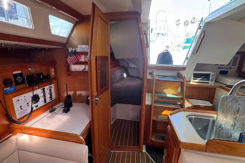 Slide: The Image of Interior of a 1997 Catalina 36 MkII sailboat, featuring navigation station and cozy cabin. - 45