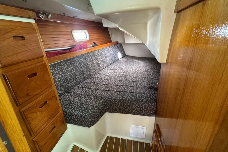 Slide: The Image of Cozy cabin interior of 1997 Catalina 36 MkII sailboat with wood paneling and patterned cushions. - 46