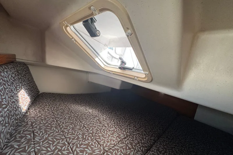Slide: The Image of Interior cabin of 1997 Catalina 36 MkII sailboat with patterned cushions and window. - 48