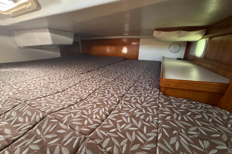 Slide: The Image of Interior cabin of a 1997 Catalina 36 MkII sailboat with patterned bedding. - 49