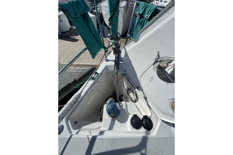 Slide: The Image of Bow of 1997 Catalina 36 MkII sailboat with anchor chain and green sail covers. - 5