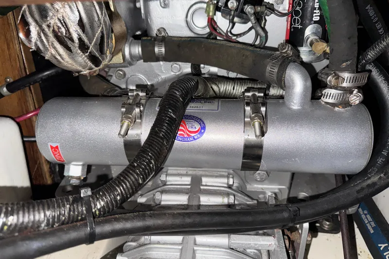 Slide: The Image of Engine compartment of a 1997 Catalina 36 MkII sailboat, featuring mechanical components and wiring. - 54