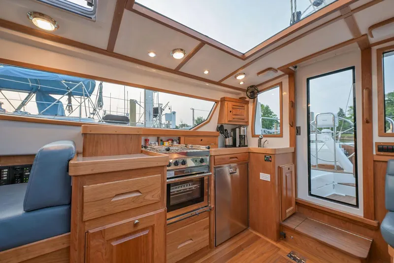 Slide: The Image of Manufacturer Provided Image: Luxurious interior of 2026 Tartan 455 yacht with modern kitchen and seating area. - 9