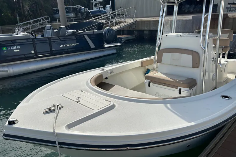 Slide: The Image of 2017 Parker 21SE Center Console boat docked at marina, featuring spacious seating. - 5