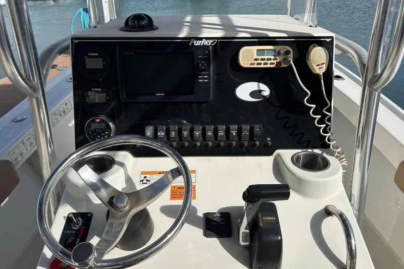 Slide: The Image of 2017 Parker 21SE Center Console boat dashboard with steering wheel and controls. - 6