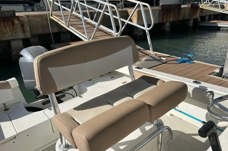 Slide: The Image of 2017 Parker 21SE Center Console boat at dock with seating and motor visible. - 9