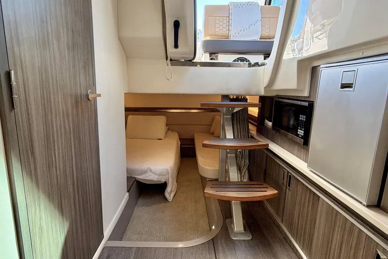 Slide: The Image of Interior of 2022 Sea Ray Sundancer 320 yacht, featuring cozy cabin and modern amenities. - 14